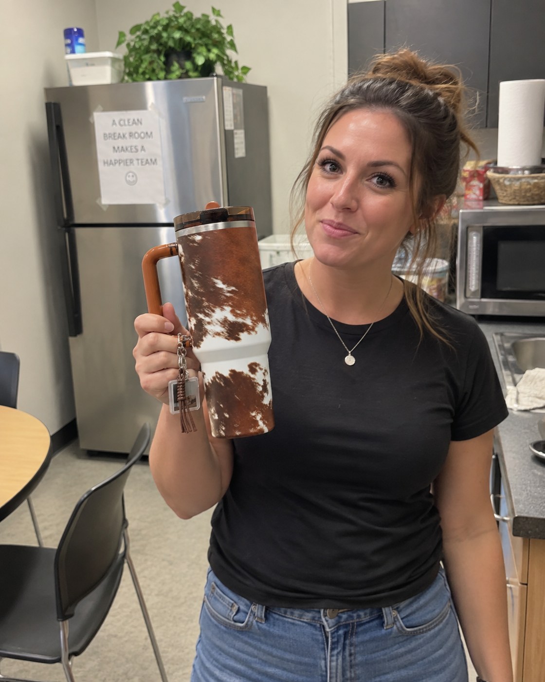 Stacy in the break room in Fort Worth holding her tumbler
